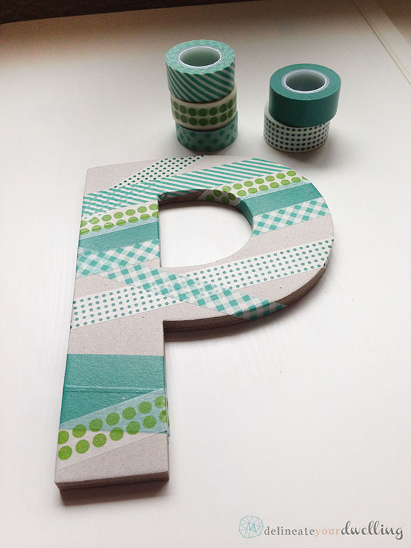 Learn how to make an adorable DIY Washi Tape Letter wall decor to hang in your child's bedroom. We used so many fun shades of green and love it. Delineate Your Dwelling #washitapecraft #boywalldecor