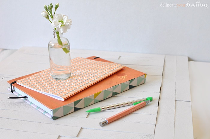 Learn how to customize your notebook cover in a few simple steps using fun and colorful scrapbook paper! Personalize your notebook to reflect your style. Delineate Your Dwelling #customnotebook #DIYnotebook #DIYjournal