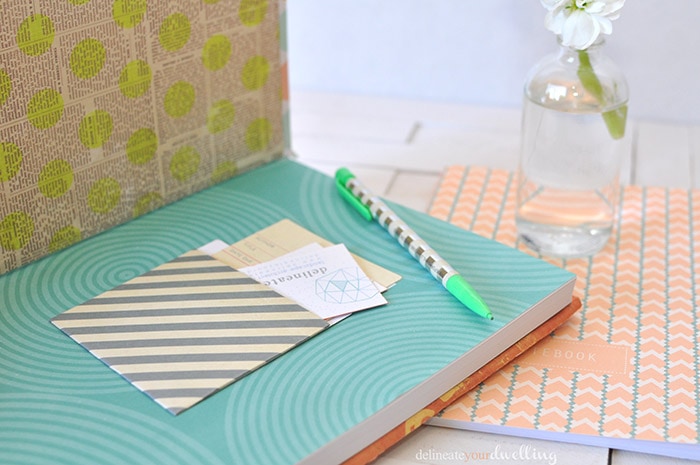 Learn how to customize your notebook cover in a few simple steps using fun and colorful scrapbook paper! Personalize your notebook to reflect your style. Delineate Your Dwelling #customnotebook #DIYnotebook #DIYjournal