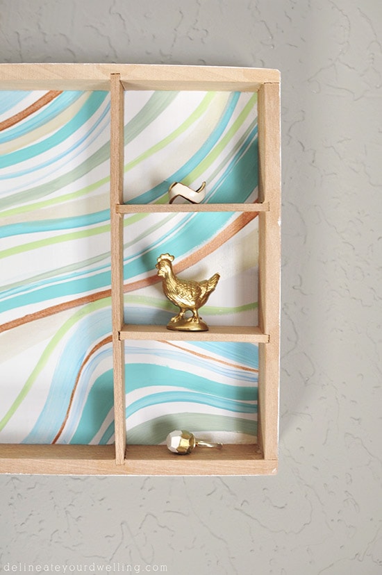 Learn how to create a statement marbled piece using simple acrylic paint and an old wooden toy container. In just a few steps you'll be painting your own Marbled Wall Shadow Box. Delineate Your Dwelling #paintedshadowbox #DIYshadowbox