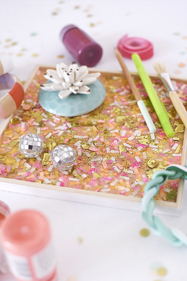 Learn the simple steps for how to make a colorful DIY Confetti Tray! There is a secret ingredient supply that really makes this a unique craft project that you can set out on display in your home. Delineate Your Dwelling #confetti #confetticraft #confettitray