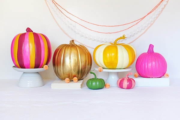 Colorful Painted pumpkins in a row