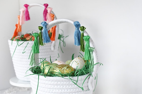 First, learn how to make tassels using Embroidery Floss. Then apply those tassels to any type of basket, making a simple and fun DIY Tassel Easter Basket for Easter this year! Delineate Your Dwelling #easterbasketDIY #tasselbasket #DIYEasterBasket #DIYEaster