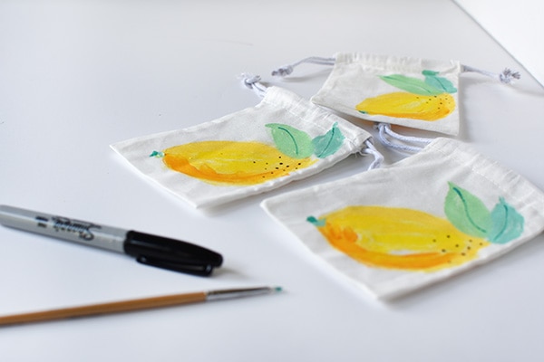 Learn how to paint fun refreshingly easy DIY Painted Lemon Bags! Adding details to lemon paint bags