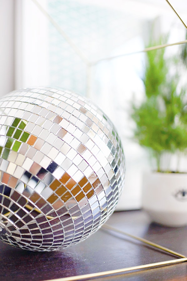 Reasons why you need a Disco Ball in your everyday home decor! Plus, ways to use different sized disco balls, the history behind them and a disco ball shopping resource. Delineate Your Dwelling #discoball #discoballhome #discoballdecor