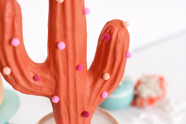 Bring some bold color to your home with a fun DIY Pom Pom Cactus! Delineate Your Dwelling