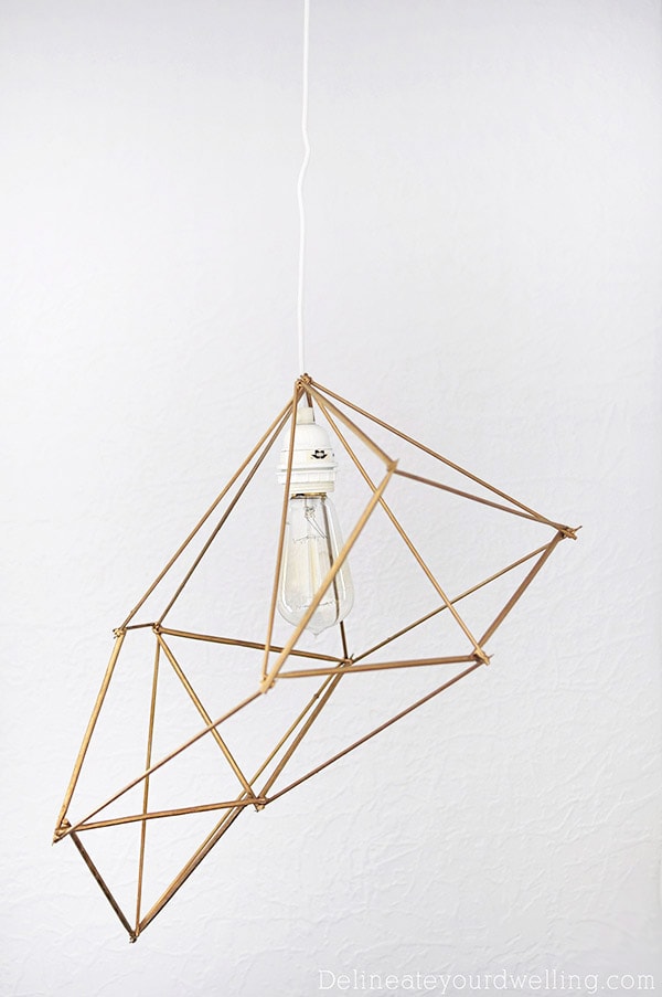 How to create an inexpensive and gorgeous Modern DIY Geometric Pendant Lamp using simple wooden skewers. Plus, it adds so much drama to your room! Delineate Your Dwelling #modernlamp #DIYlamp