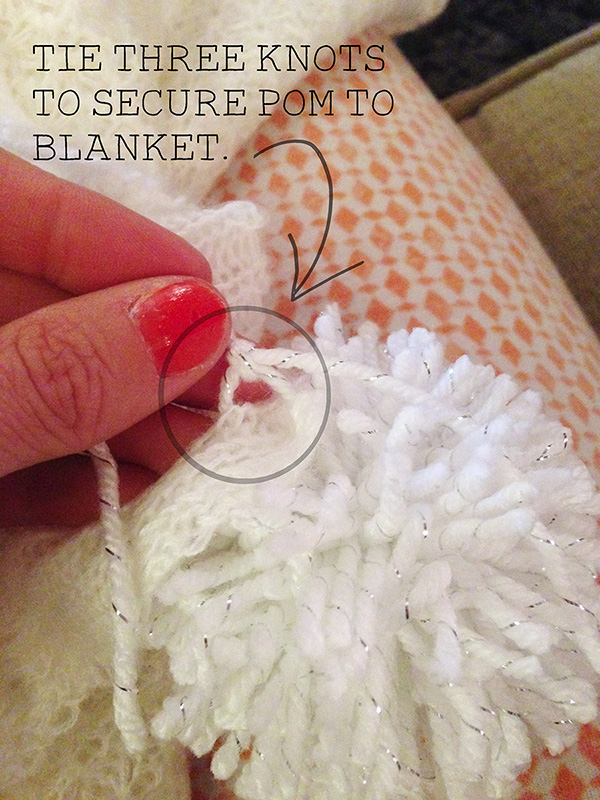 Adding pom pom to blanket