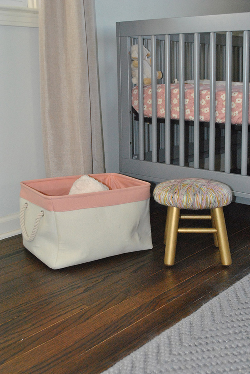 Gray crib, pink basket
