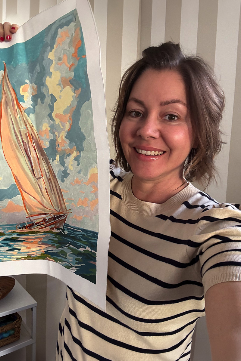 Woman holding Paint by number sailboat