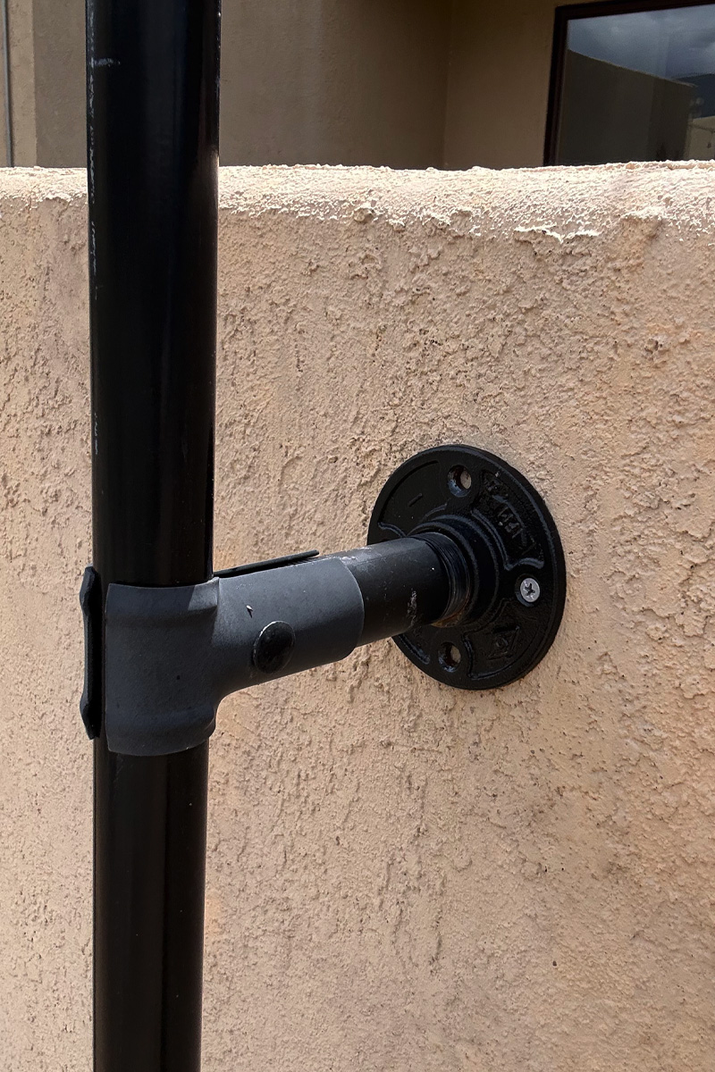 Black circular base plate for stucco wall pole mount