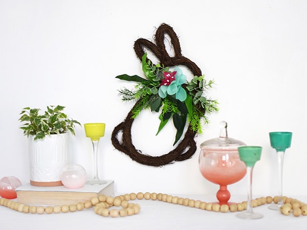 Learn how to make a festive DIY Easter Bunny Grapevine Wreath to hang on your wall this Spring.  Delineate Your Dwelling #BunnyWreath #BunnyGrapevinewreath #Eastergrapevinewreath