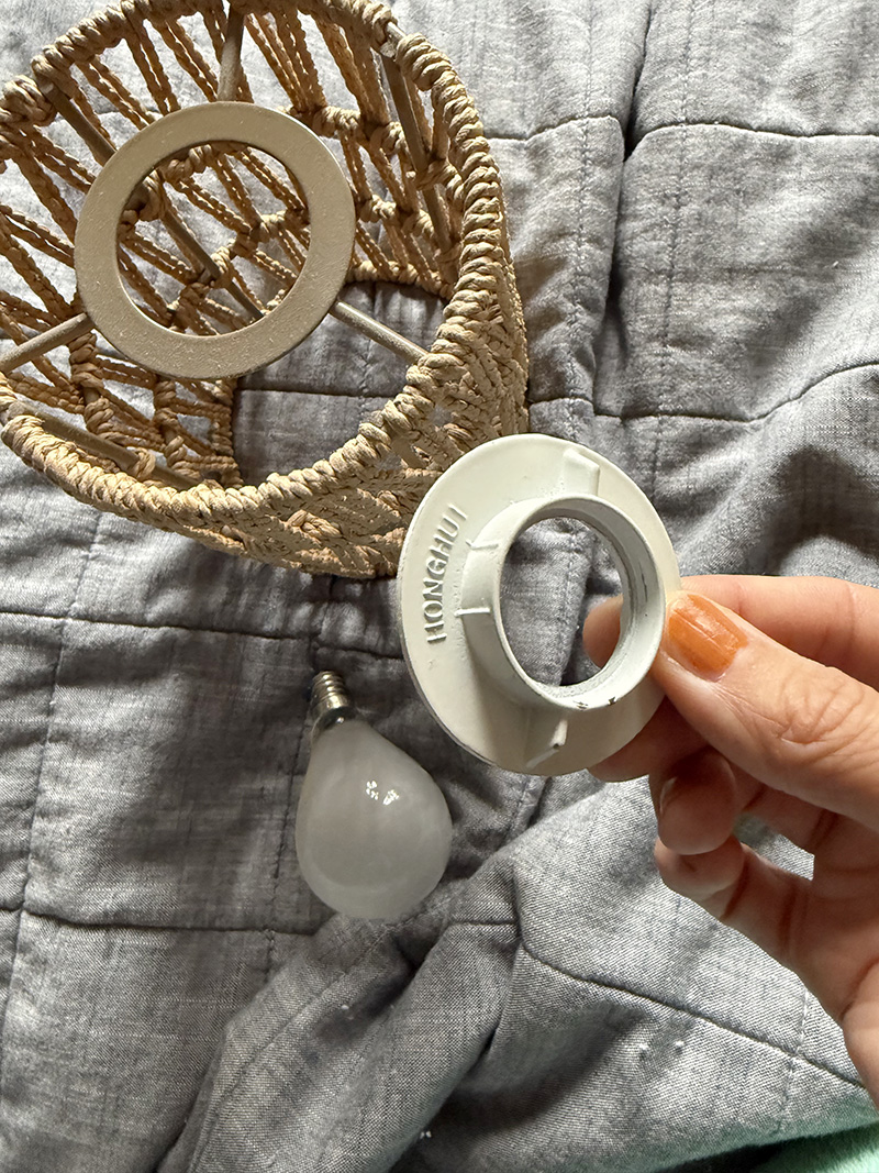 Rattan shade, light socket shade ring and light bulb
