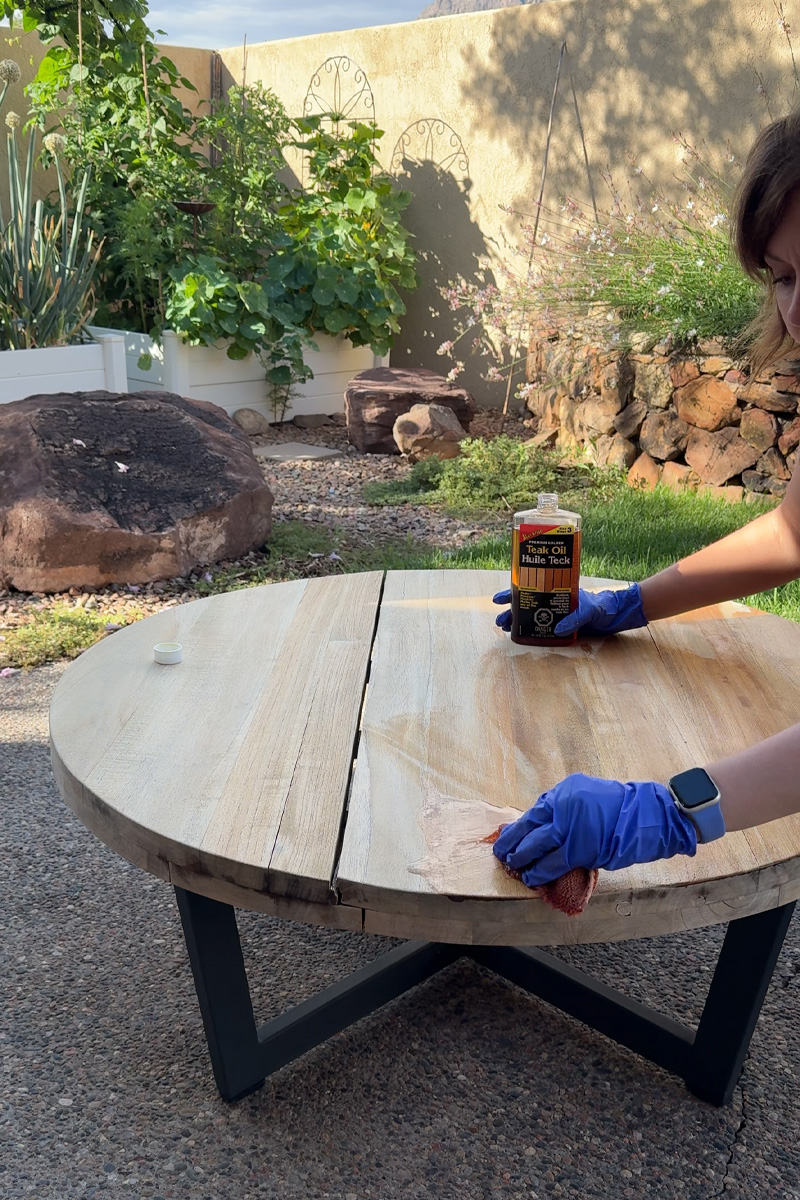 Applying teak oil to table