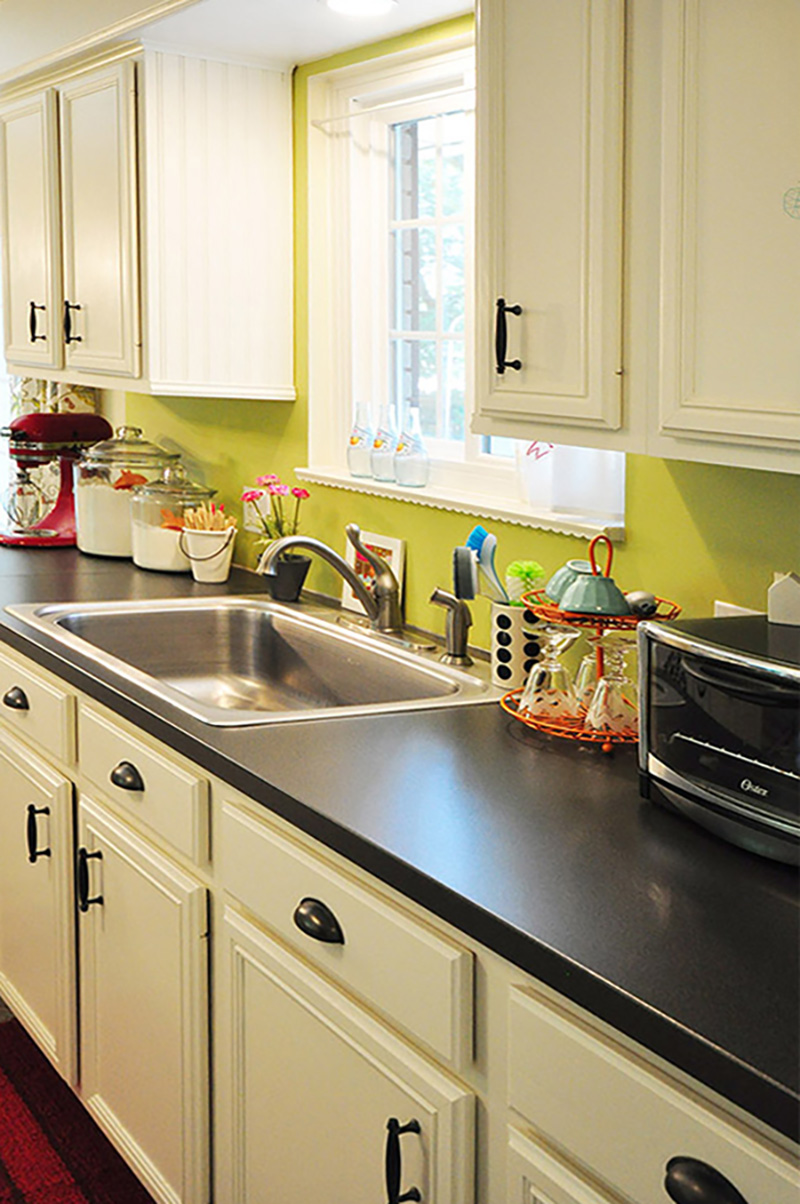 White cabinets with green wall kitchen