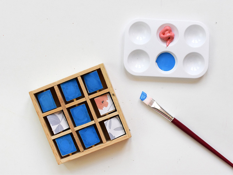 Painting blue paint on wooden blocks