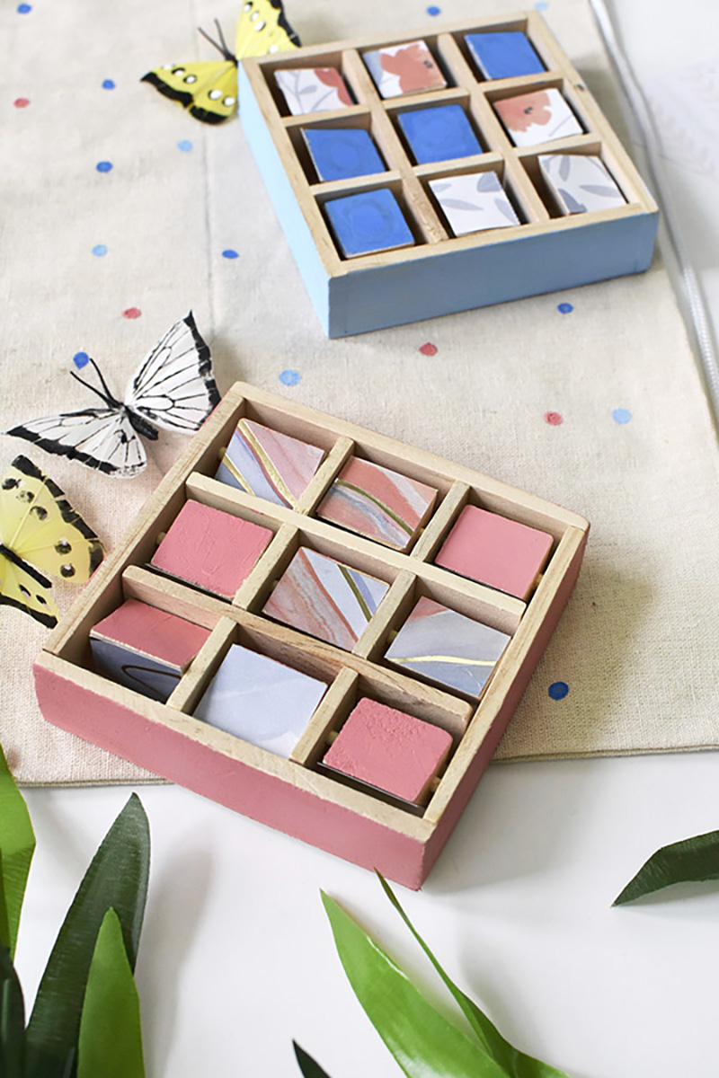 Pink and blue wood tic tac toe game with butterflies