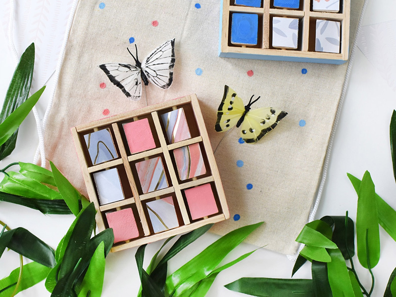 Cheerful tic tac toe game with butterflies and greenery