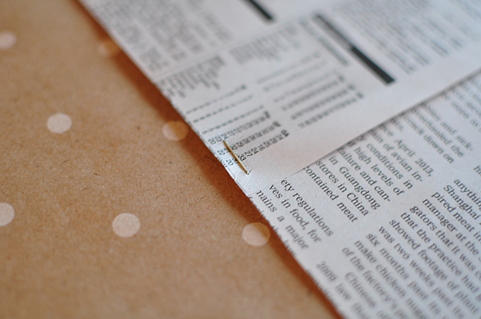 Staple newspapers together