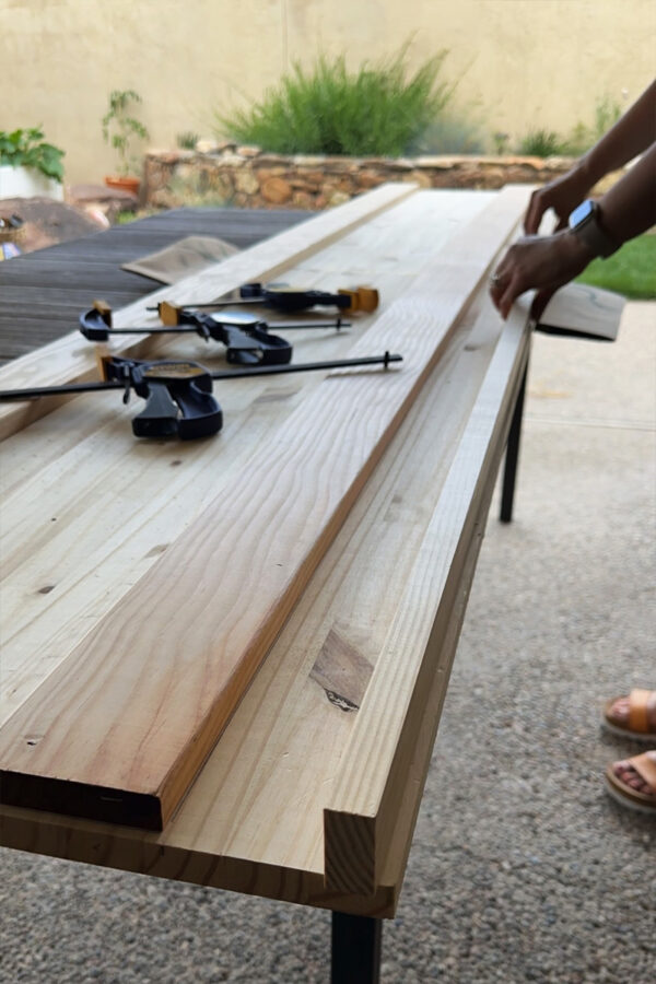 Securing wood trim to the front of a bar top