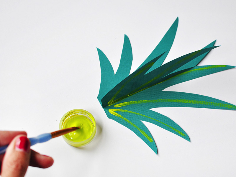 Tall teal paper grass with neon yellow paint stripes