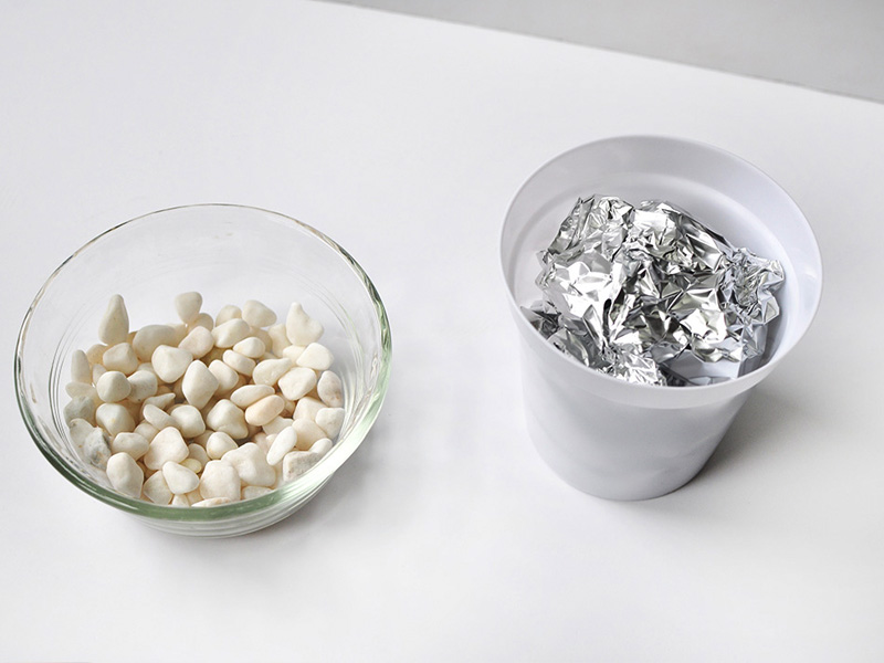 White rocks with aluminum foil ball in pot