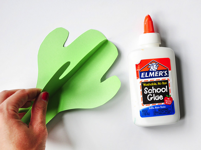 Bright green paper cactus secured together with glue