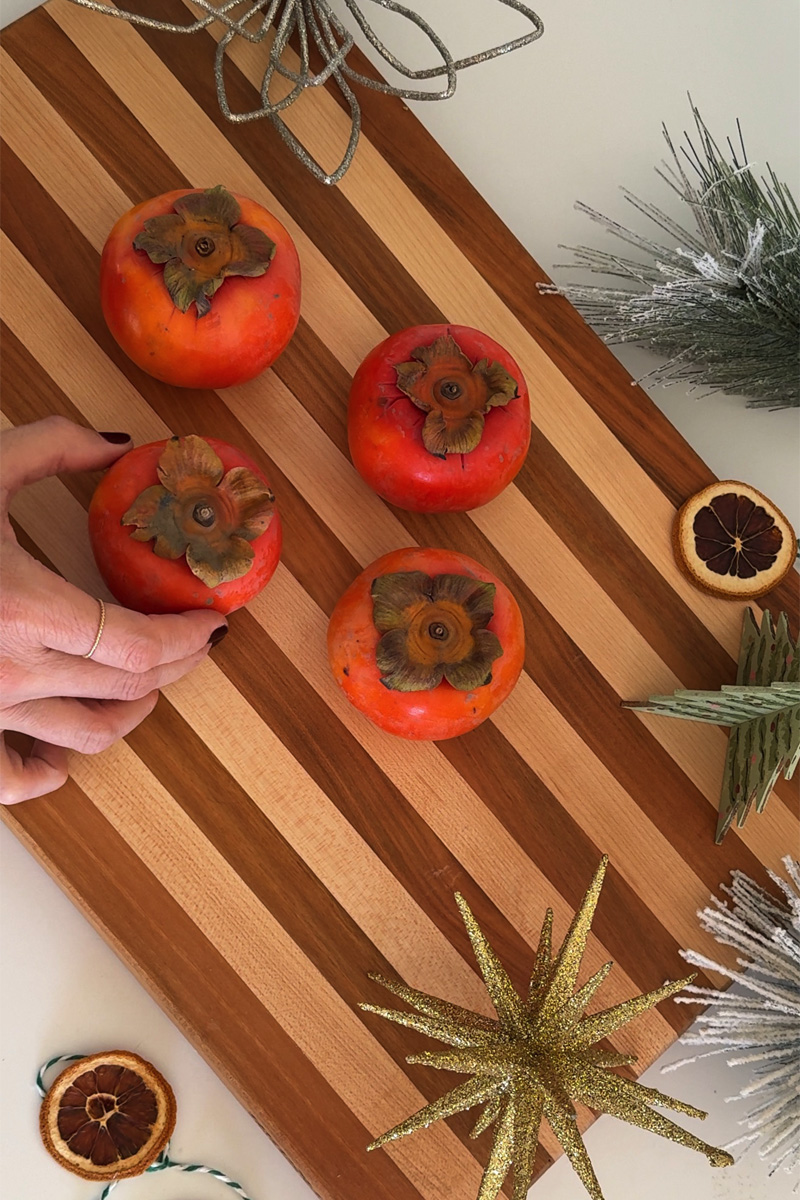 Holiday Persimmon fruit on a cutting board