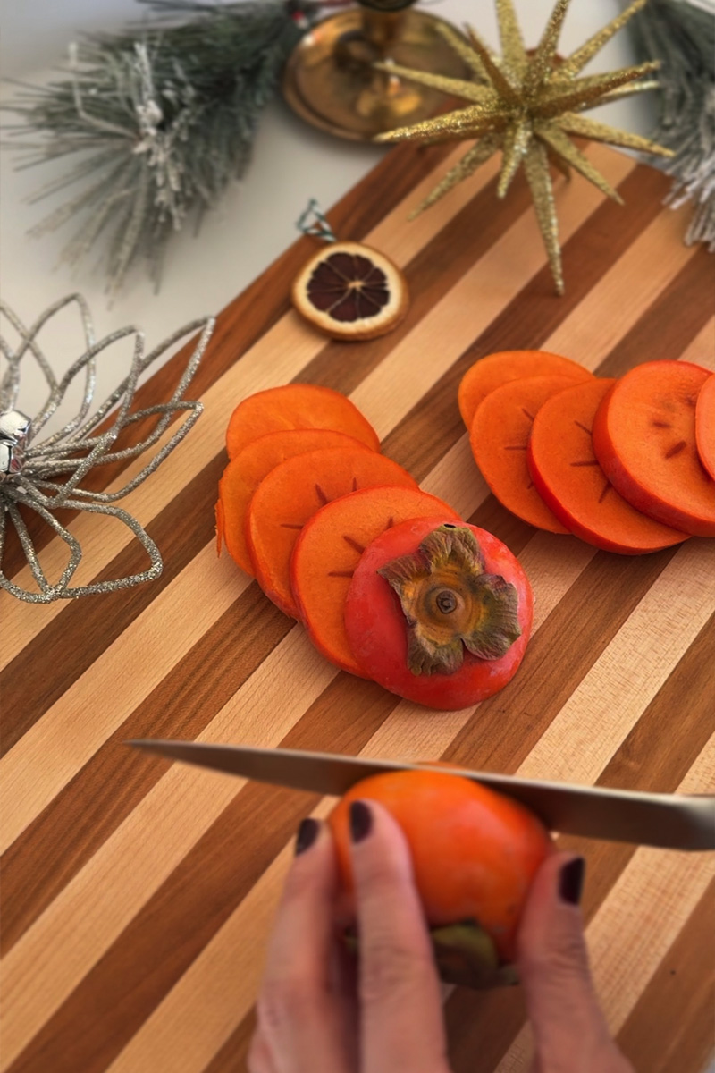 Sliced Persimmon on a butcher block board