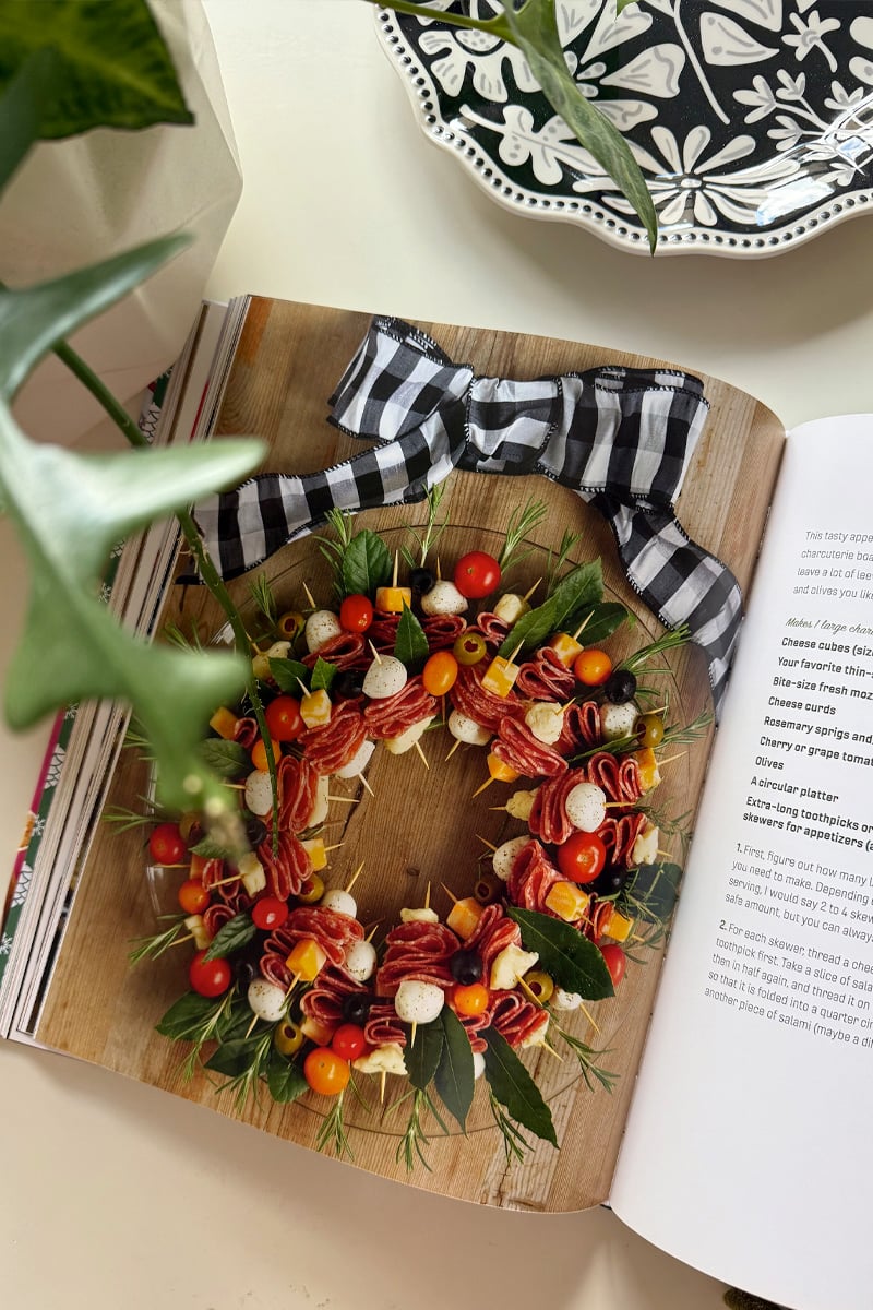 Festive Holiday Charcuterie appetizer wreath from book sitting out on a table