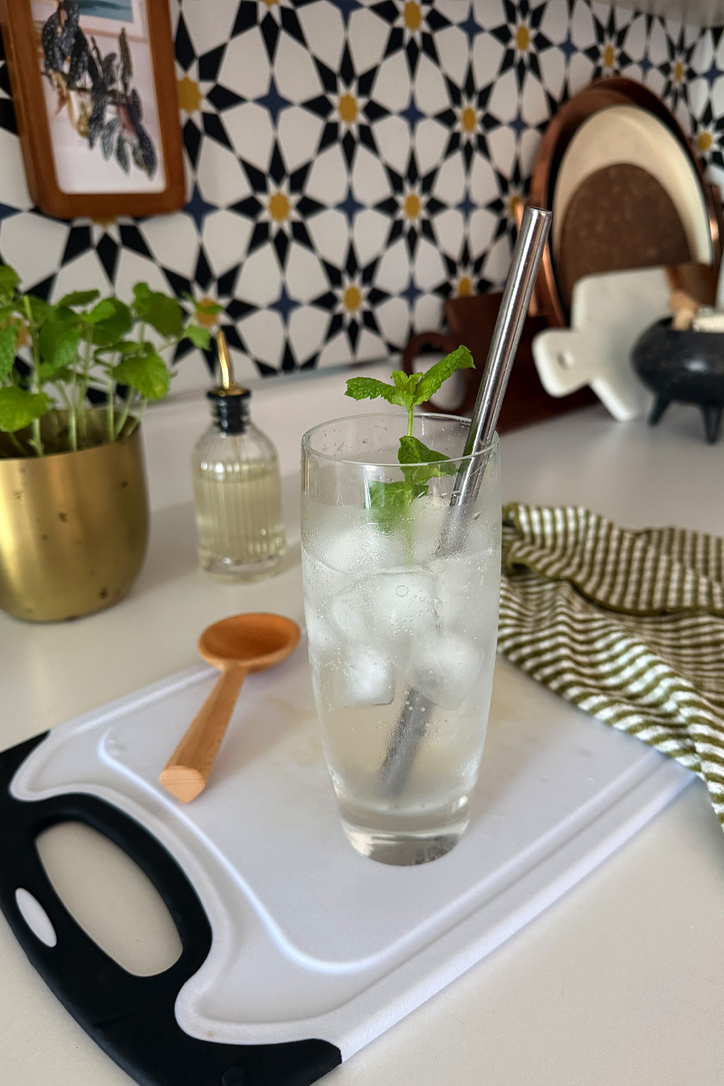 Mint and Sparkling Water mocktail drink in a glass with ice on a cutting board