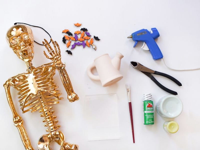 Gold skeleton, mini wooden bats, paint, hot glue gun supplies