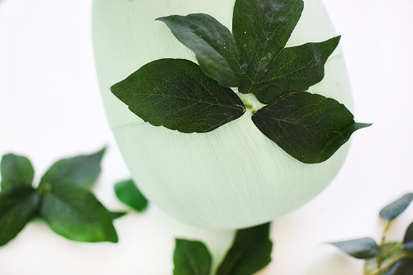 Learn how to make gorgeous Greenery Easter Egg Decor : Adding leaves.