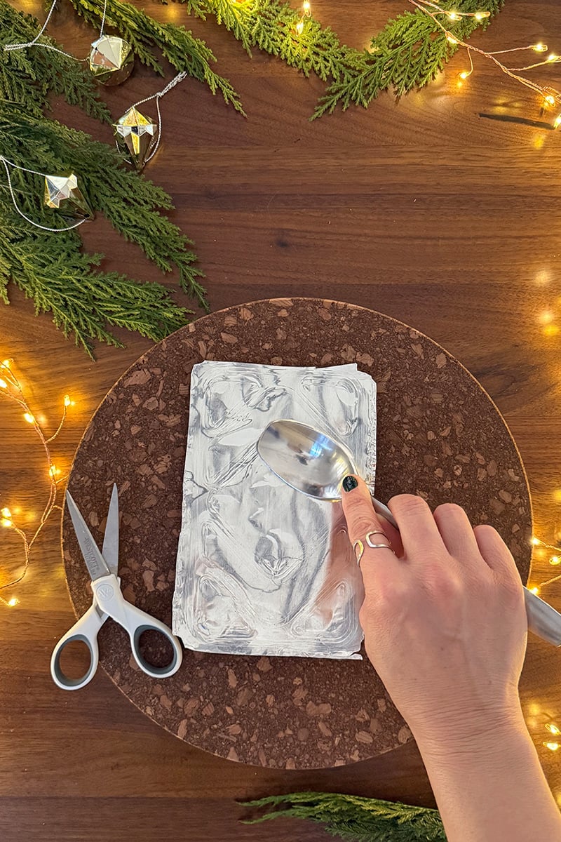 Using a spoon to smooth out metal