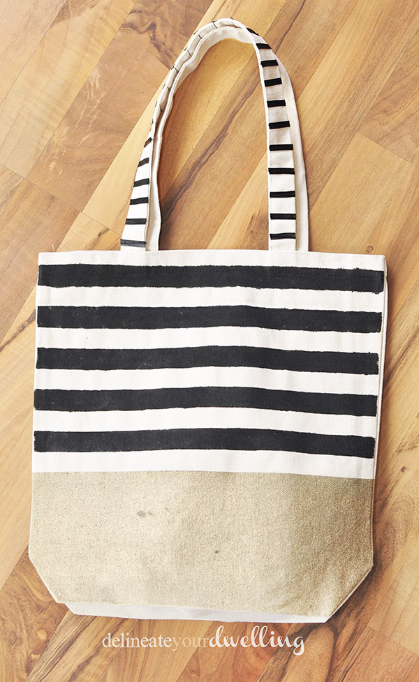 Learn how to create a gorgeous DIY Striped West Elm inspired tote bag! Perfect for carrying your miscellaneous items around in style. Delineate Your Dwelling #stripedtotebag #canvastotebag #DIYcanvastote