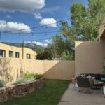 Installing Backyard String lights - desert stucco house