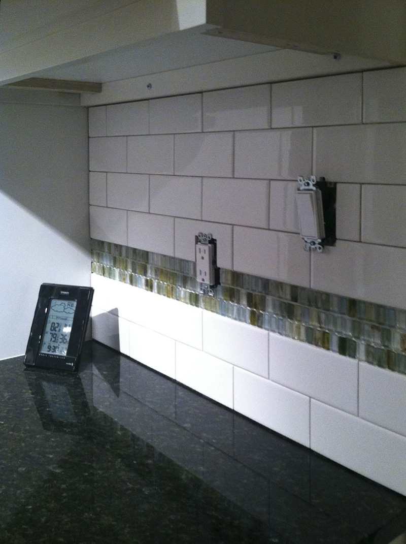 White subway tile backsplash with accent row
