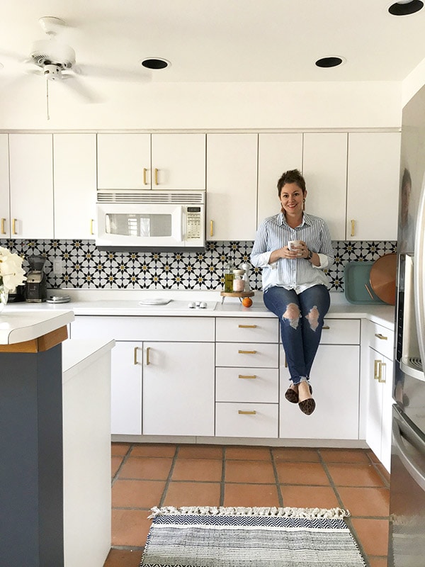 Women sitting on kitchen countertop