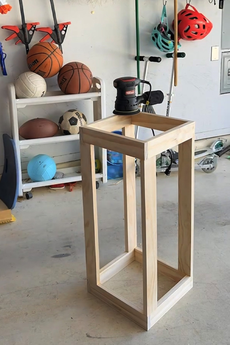 Electric Hand Sander on wood planter