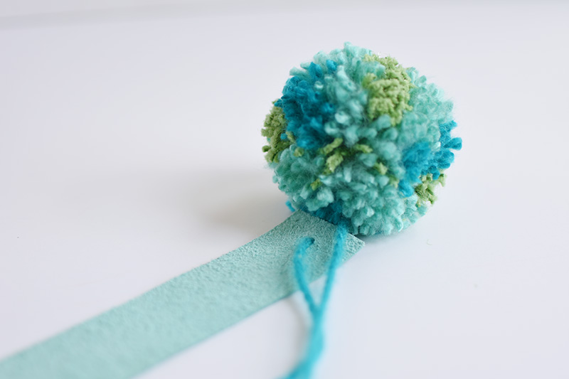 Teal and green pom pom