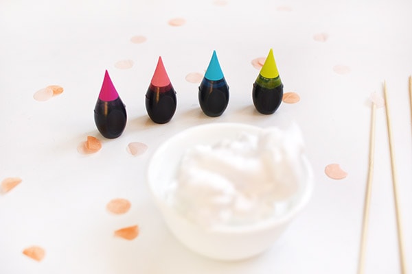 Four food coloring drops, shaving cream