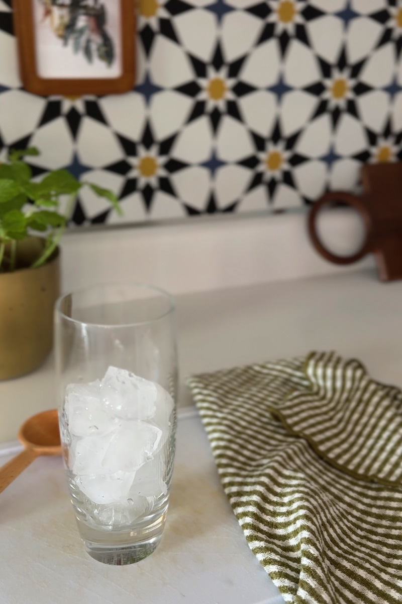 Drinking glass full of ice in a kitchen
