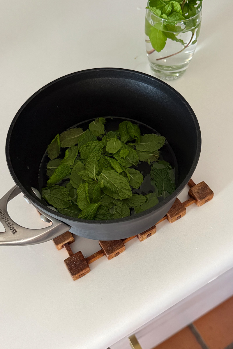 Pan of mint leaves steeping in sugar water