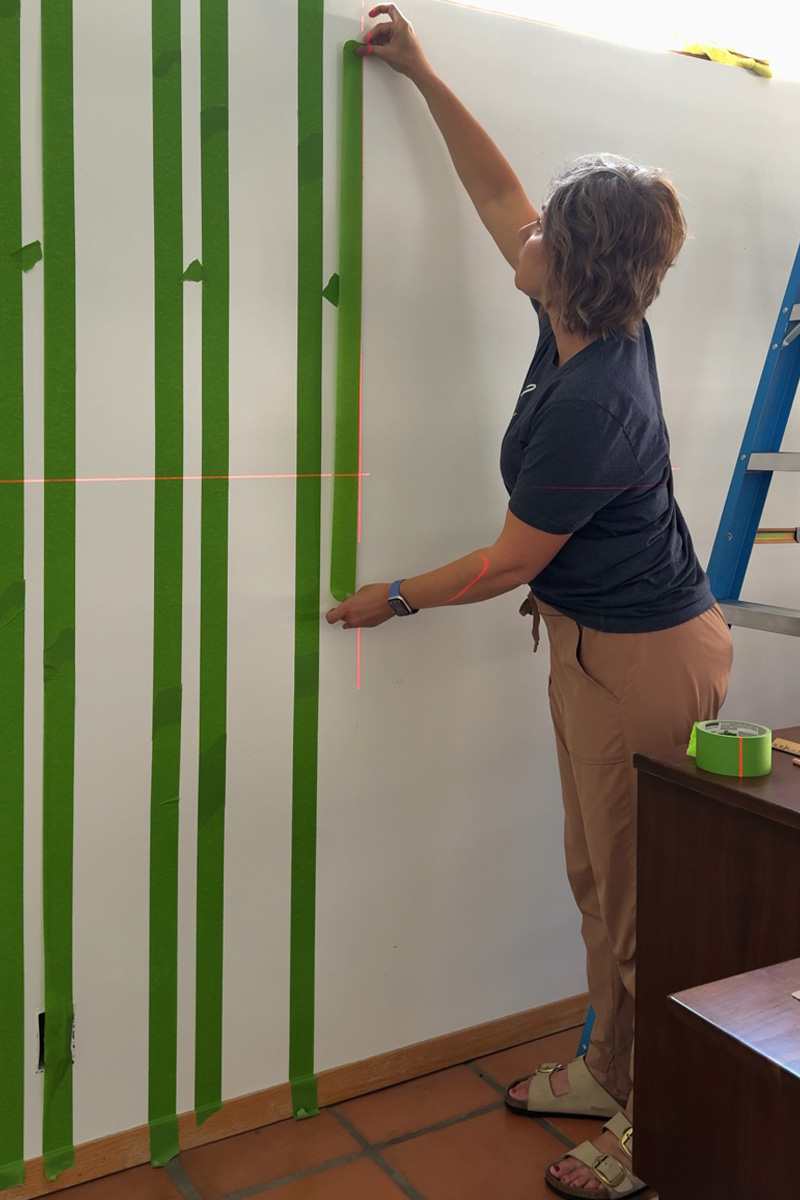 Putting up painter's tape in stripes