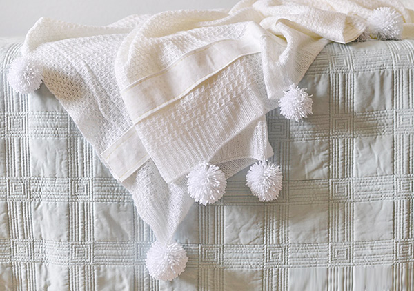 White Throw Blanket on bed