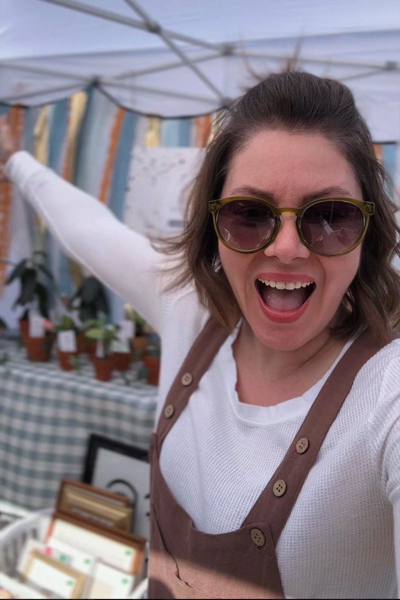 Market seller full of joy in booth