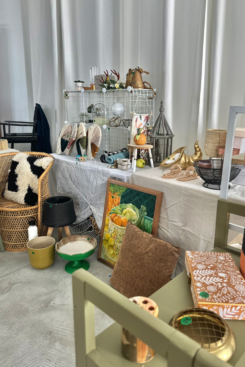 Indoor craft show displaying home decor and thrifted items