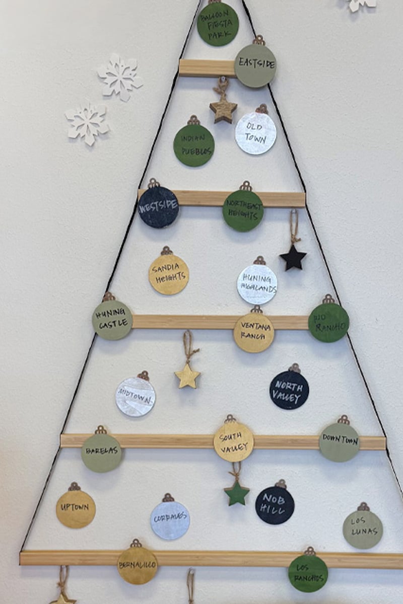Hanging Christmas tree display with ribbons and wooden ornaments