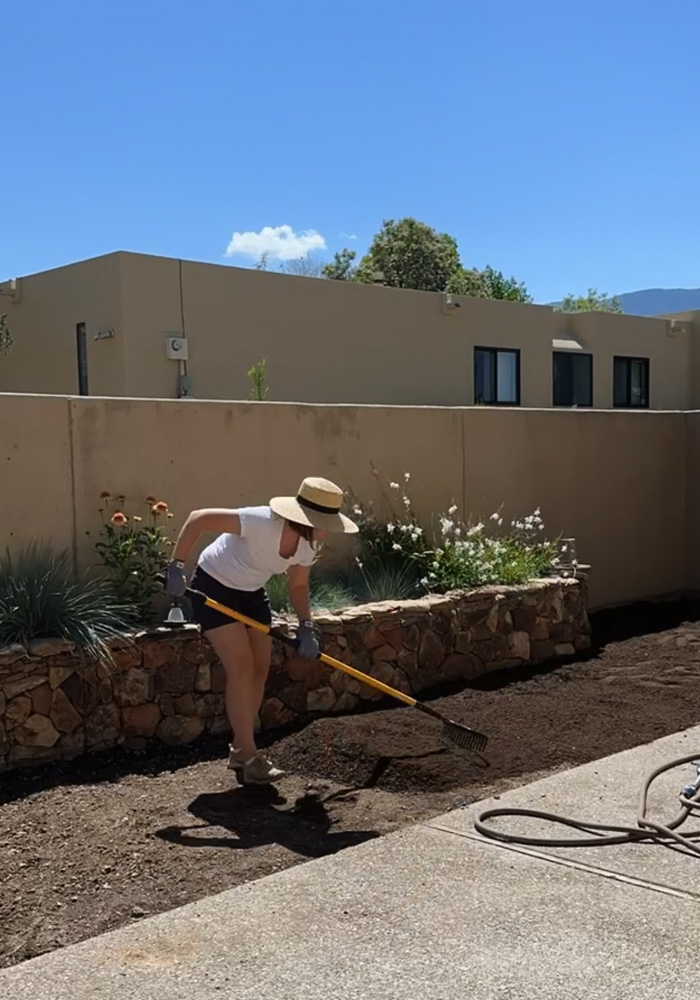 Spreading topsoil with a rake