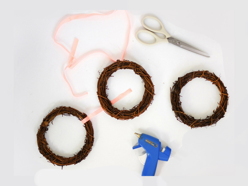 Add peach ribbon to wreaths